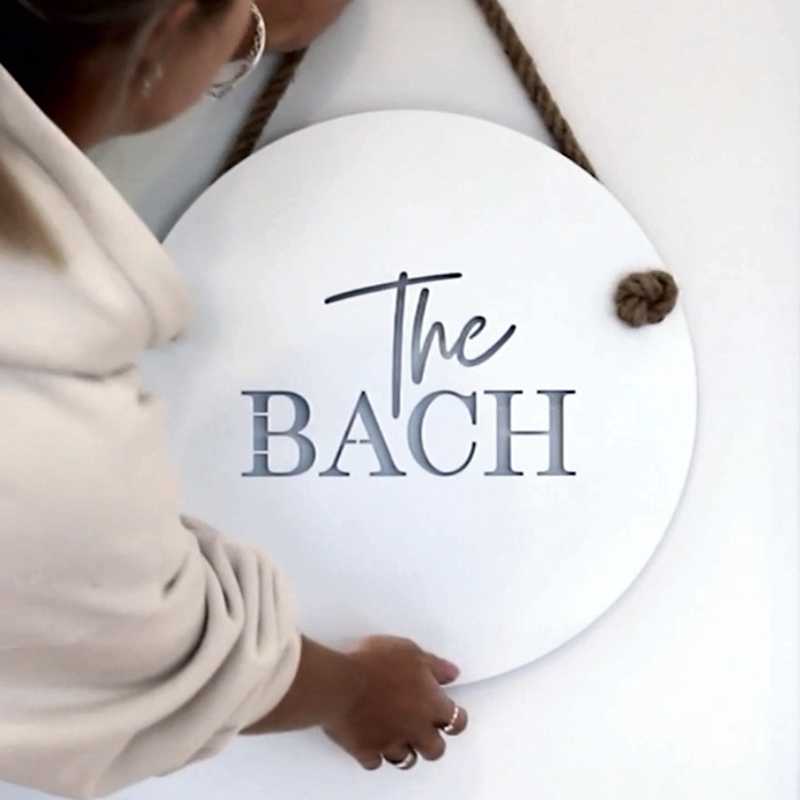 New Zealand made white steel outdoor artwork ideas The Bach wall sign for outdoors by LisaSarah Steel Designs