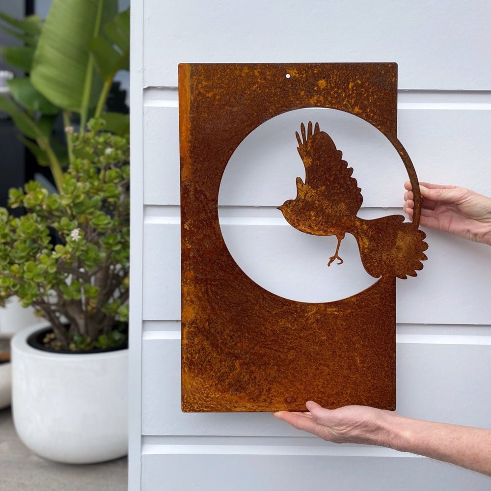Corten steel fantail in flight wall art for outdoors. NZ bird art for garden.