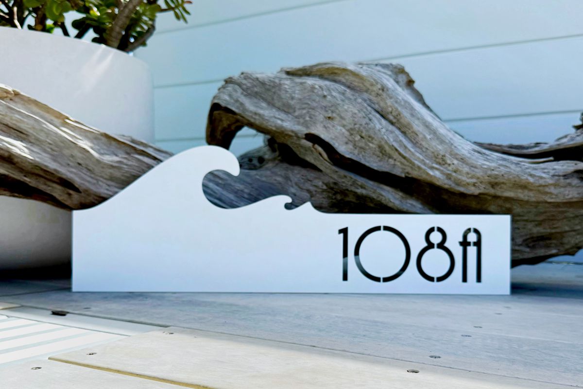 Custom steel address sign designed and made in New Zealand for an outdoor home exterior