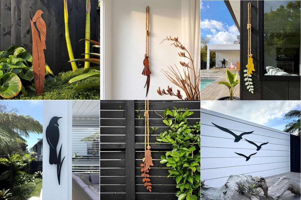 Corten steel bird on a koru garden stake against a black fence, one of the NZ garden art trends for 2026