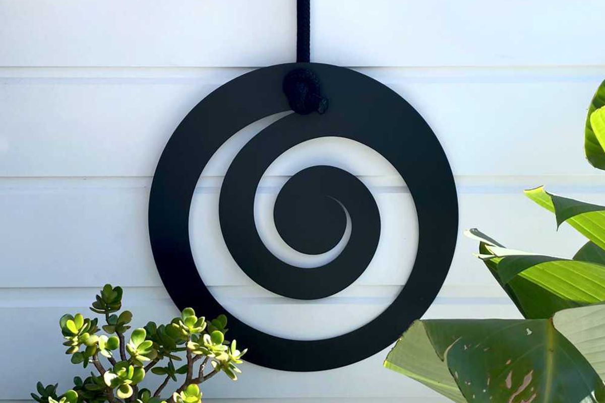 Powder-coated steel metal wall art installed on a New Zealand home exterior