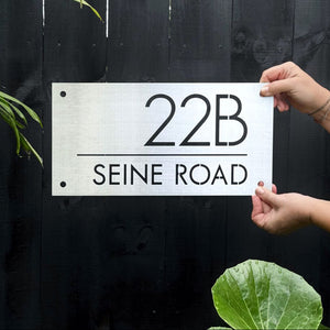 40cm x 20cm 316 brushed stainless steel address sign mounted on black fence at New Zealand home