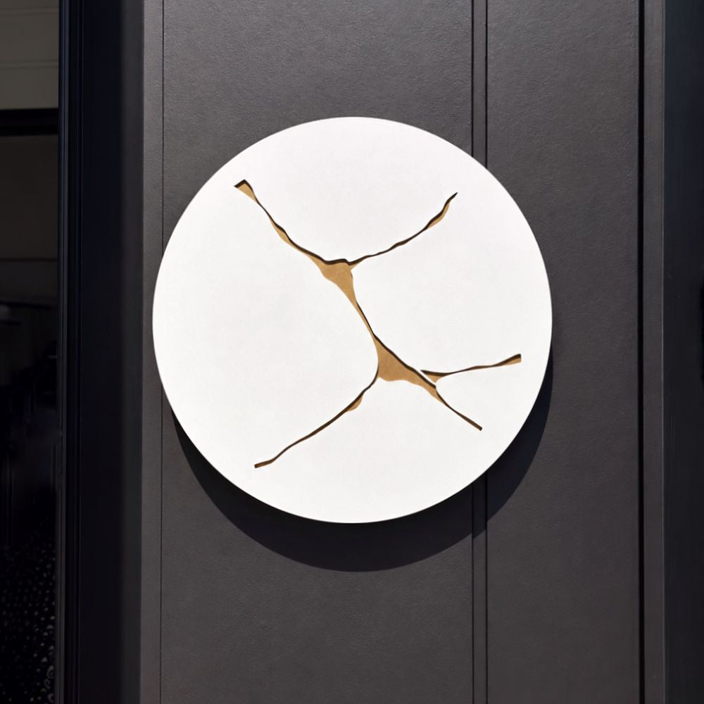 Large round white and gold wall art in aluminium on outdoor wall in modern home. 