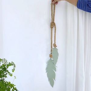 Small feathers and rope wall decor for indoors oand out.  Trending for 2024 by Lisa Turley. 