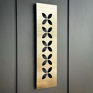 Side view of NZ Designers LisaSarah's bronze pewter steel wall art on patio wall in NZ home. 