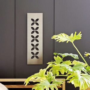 Steel bronze frangipani New Zealand Wall Art on fence in NZ home. 