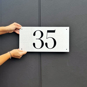 Custom marine-grade stainless steel house number sign with brushed finish, designed for New Zealand homes