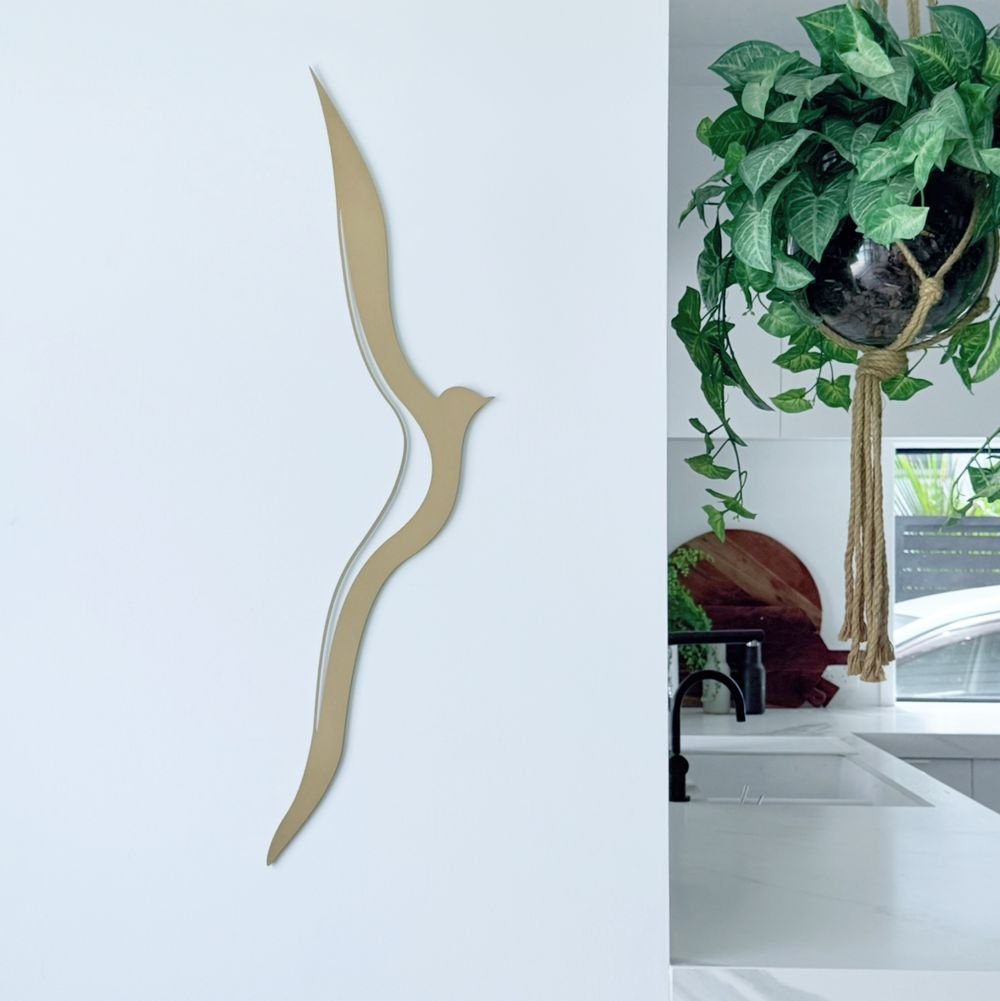Modern gold albatross in flight vertical wall art on modern living room wall in New Zealand. 