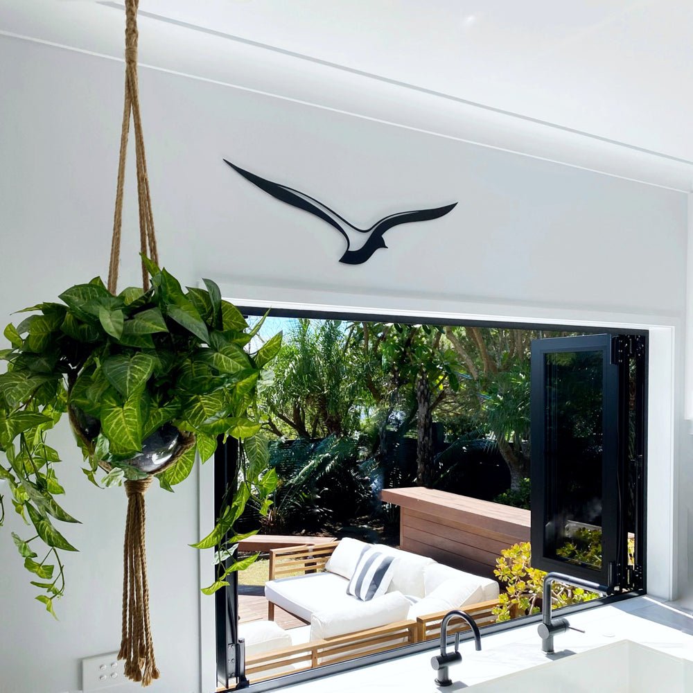 NZ made bird wall art in black steel shown in modern NZ kitchen. 