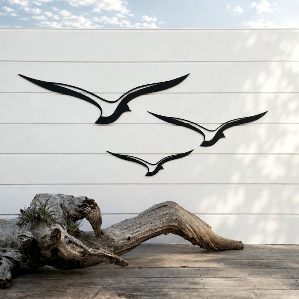 Close-up of black aluminium bird wall art on a backyard fence, weatherproof outdoor wall art designed in New Zealand.
