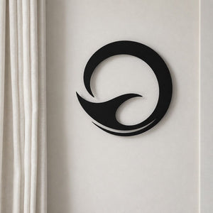 Matt black aluminium whale tail wall art, 40cm circle, hanging in a New Zealand home