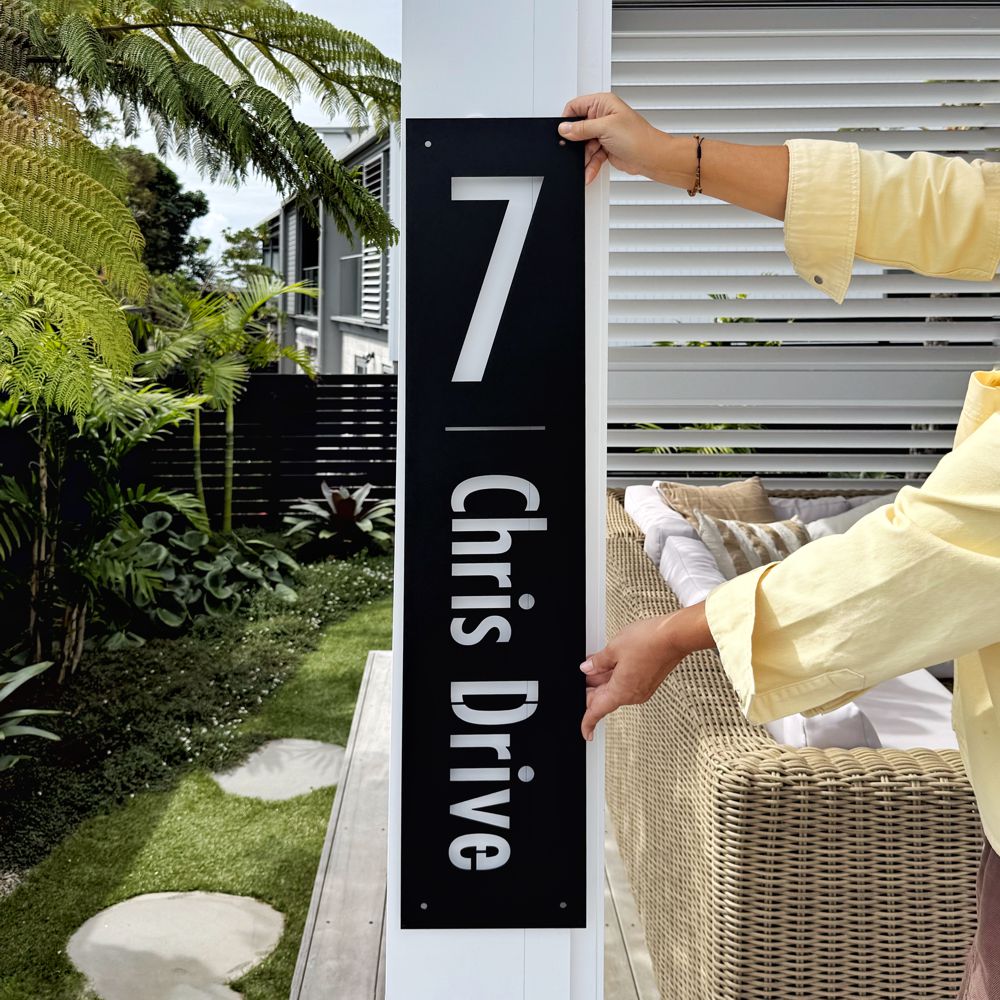 custom black steel address sign beside front entrance NZ home