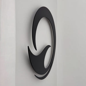 Detail of the custom hanging blocks on the back of a matt black whale tail wall art