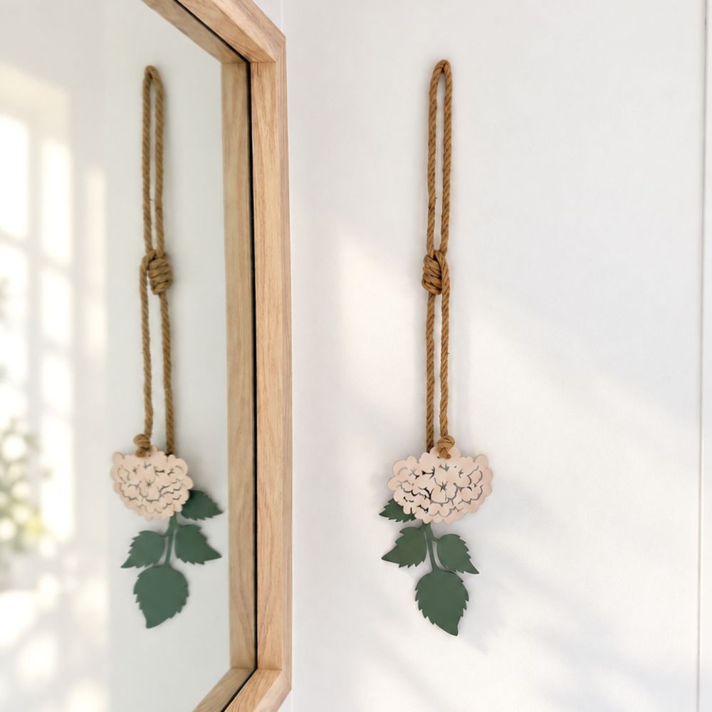 Blush pink hydrangea steel wall art hung above the bed in a bedroom