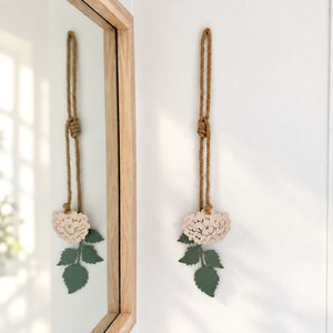 Blush pink hydrangea steel wall art hung above the bed in a bedroom