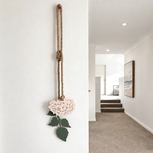 Blush pink hydrangea steel wall art displayed in a modern hallway