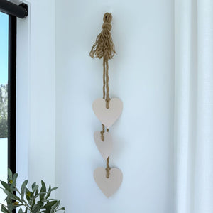 Blush pink stainless steel hearts wall hanging displayed in an Auckland living room, elegant NZ gift and home décor by Lisa Sarah