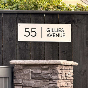 Marine-grade brushed stainless steel custom address sign reading '55 Gillies' outside a new coastal home in New Zealand