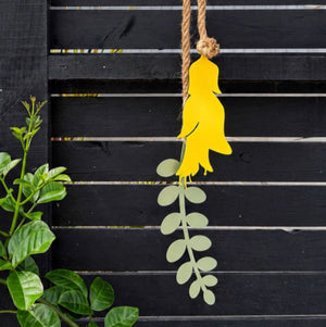 Close up of the yellow powdercoated kowhai flower and sage green leaf