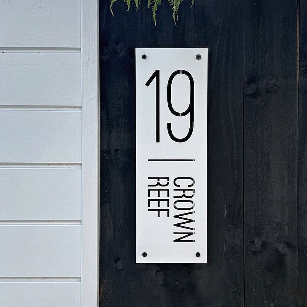 Coastal custom address sign on fence in home in Pauanui, New Zealand