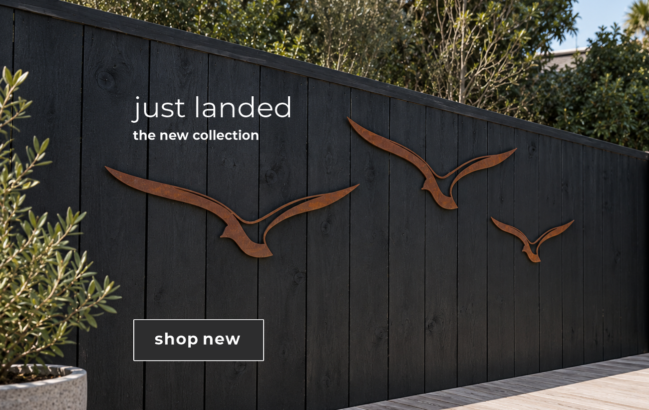 Corten steel birds wall art on fence in backyard in modern home in Auckland, New Zealand