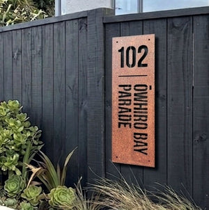 Rusted steel address sign mounted on exterior wall Wellington, New Zealand home