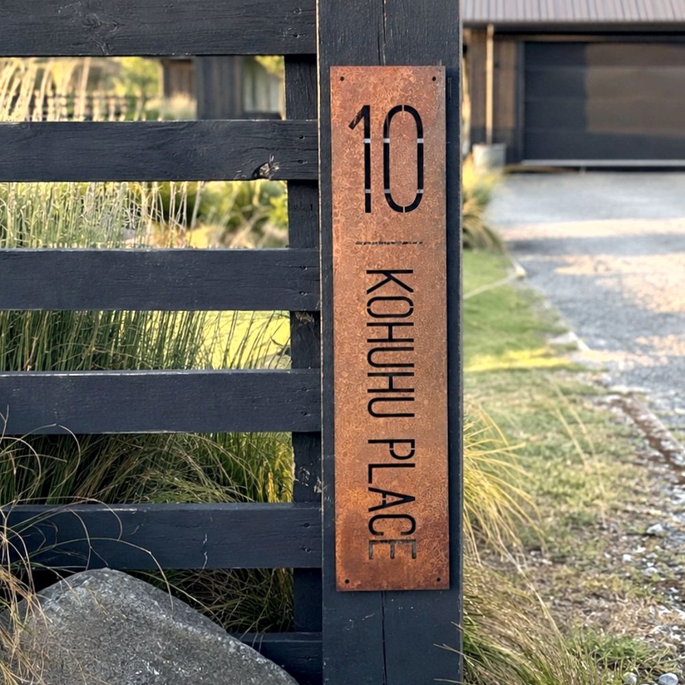 Corten steel custom address sign outside a rural property in South Island, New Zealand. 