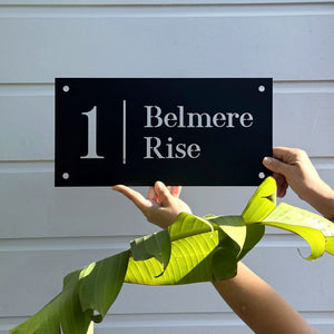 Traditional House Numbers in black steel on home in Auckland, New Zealand. 