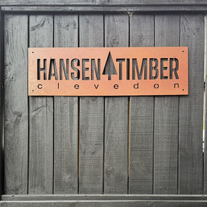 Corten steel business signage on black fence in Auckland, New Zealand