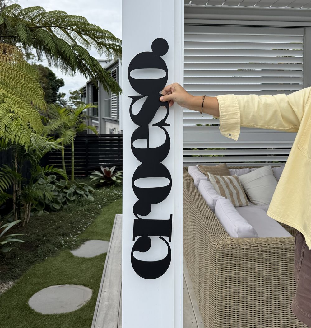 personalised black steel word sign installed NZ exterior