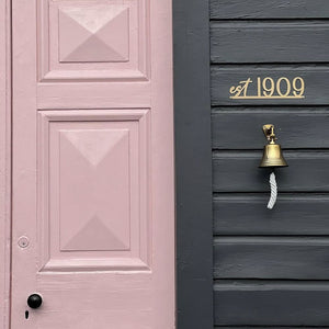 Minimal gold steel house sign with est year on historic Fairlie home New Zealand exterior