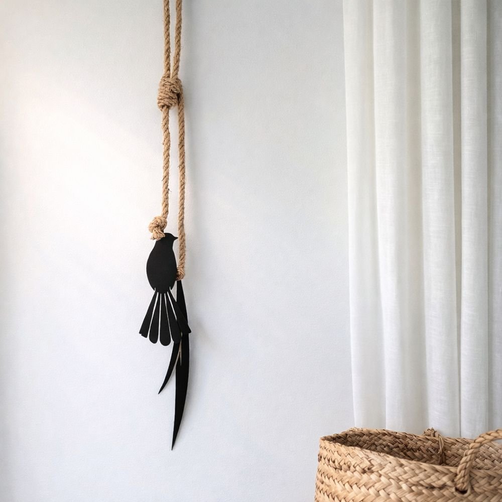 Fantail and flax metal wall hanging installed indoors on living room wall in New Zealand
