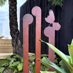 Outdoor corten steel fantail and koru sculpture stakes as NZ garden ornaments