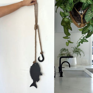 Black steel snapper and hook wall hanging in a New Zealand bach, thoughtful fisherman gift