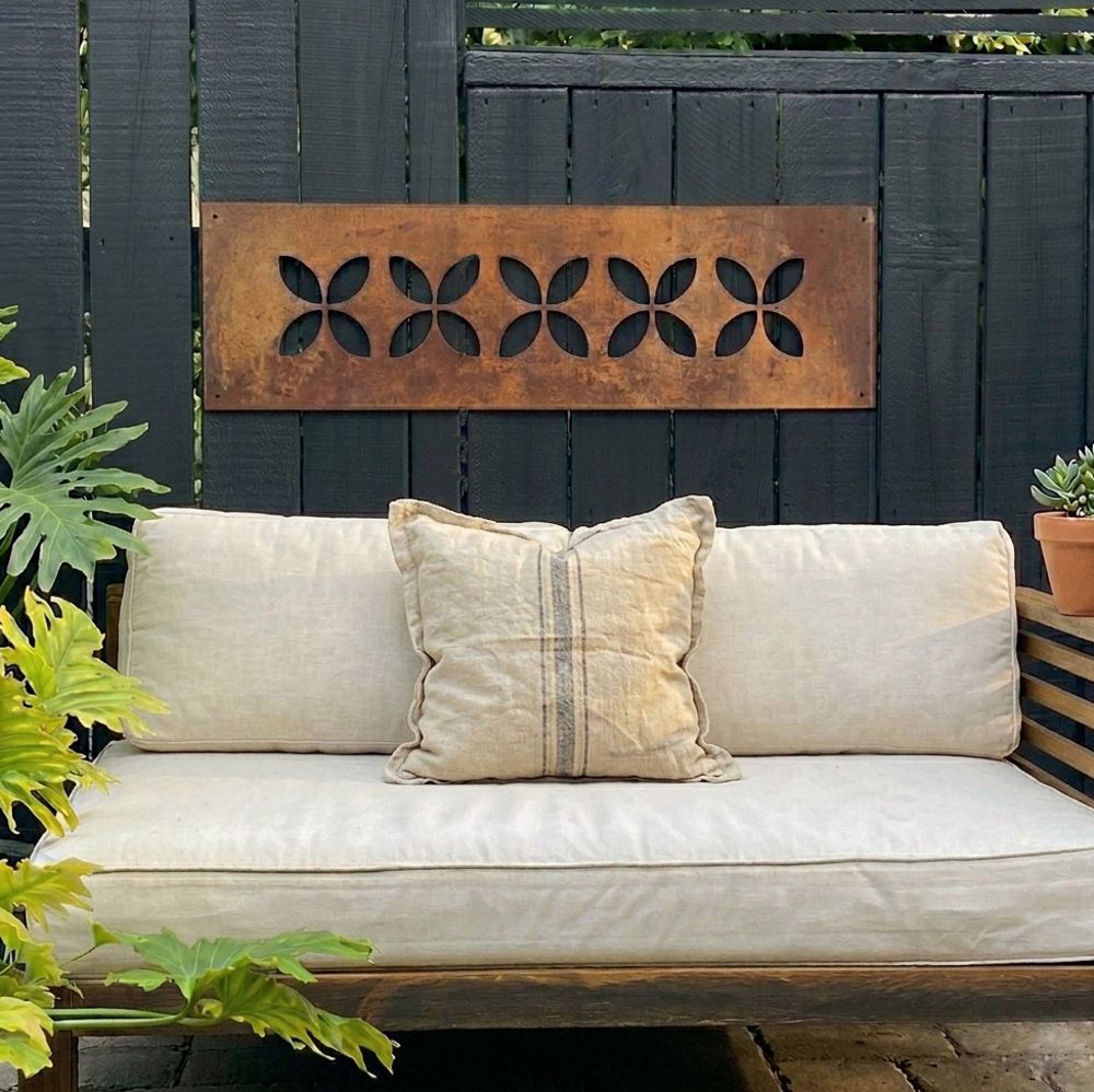 Large corten steel frangipani wall art on fence – NZ home outdoor setting – LisaSarah Steel Designs