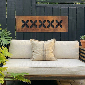 Large corten steel frangipani wall art on fence – NZ home outdoor setting – LisaSarah Steel Designs