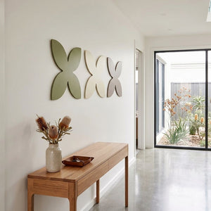 Modern frangipani wall art in NZ home, steel wall art for living room, minimalist coastal style wall decor New Zealand