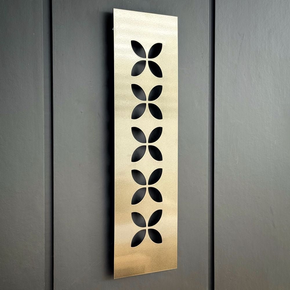 Steel bronze frangipani New Zealand Wall Art on fence in NZ home. 