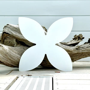 Outdoor white frangipani metal wall sculpture in Lisa’s native New Zealand garden