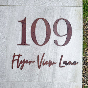 Modern corten steel custom address sign on stone tiles in New Zealand