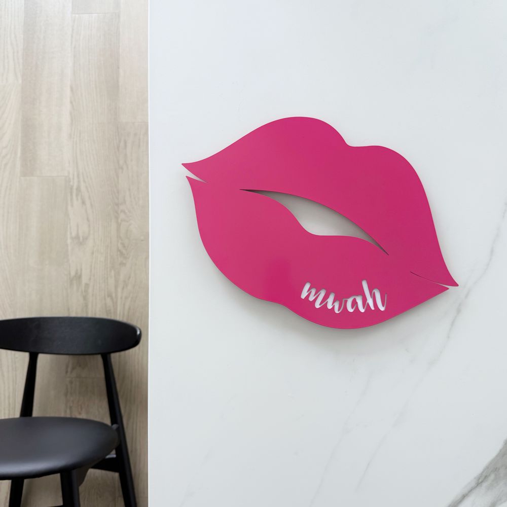 Hot pink steel wall art NZ – “mwah” cut-out design for indoor and outdoor spaces