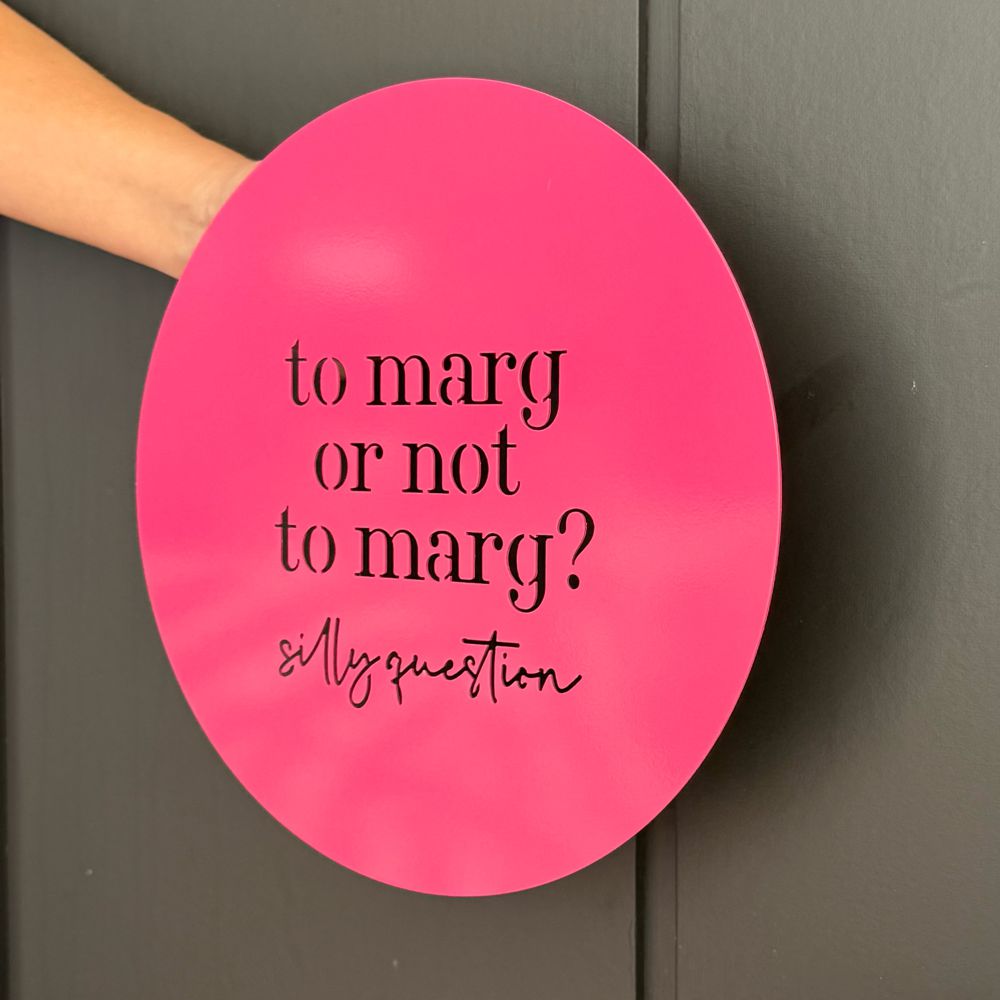 Bright pink wall art with the quote ‘to marg or not to marg’ fun cocktail themed décor