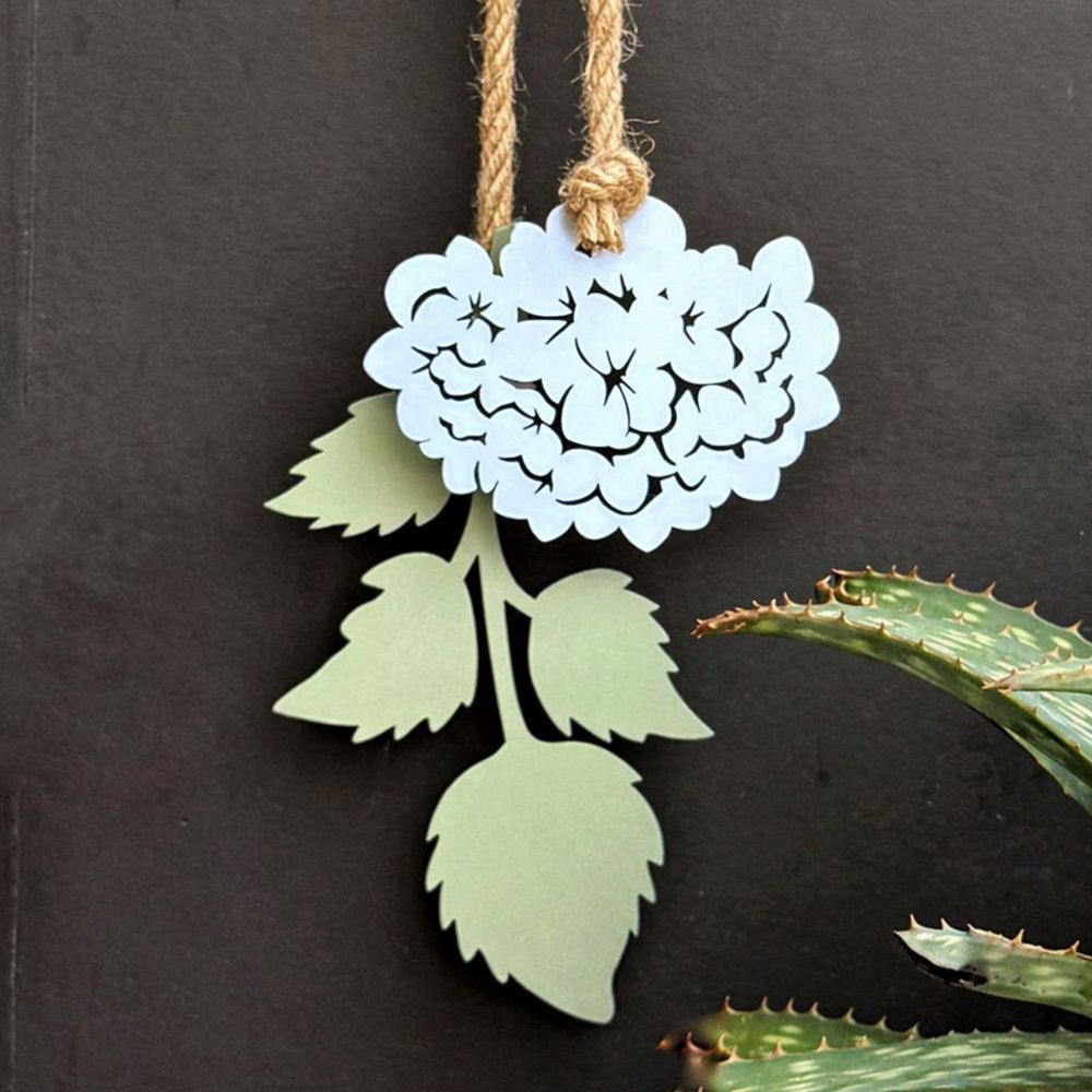 Hydrangea wall art in pale blue steel with soft green leaves, minimalist NZ-made outdoor hanging decor