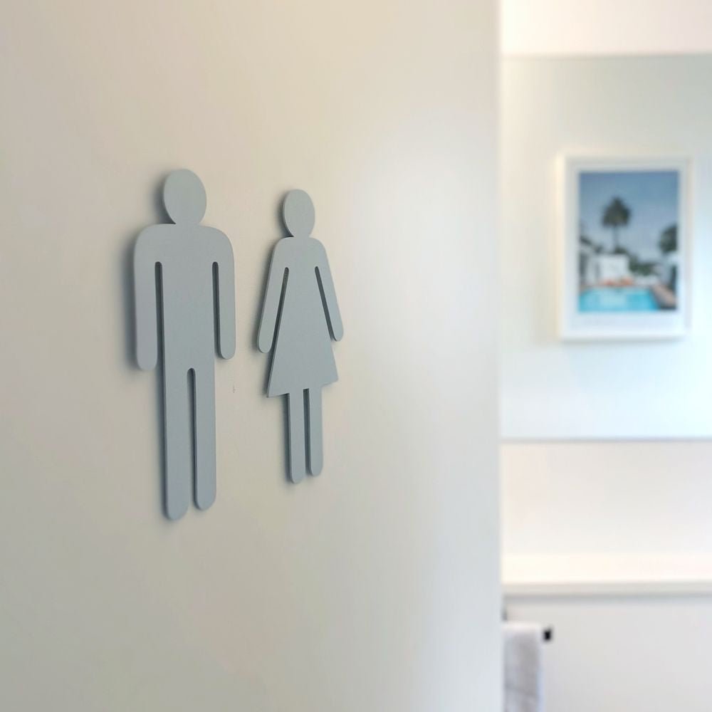 Pale blue bathroom symbols for powder room in New Zealand home. 