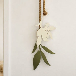 Close up of the sage green coated steel leaf on a magnolia wall hanging