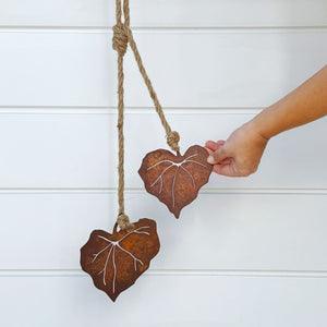 Close-up of kawakawa leaf cutout in corten steel.