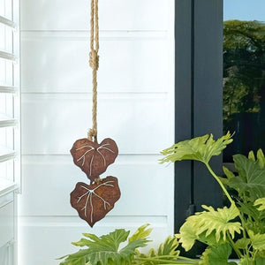 Kawakawa steel artwork displayed on outdoor wall in NZ.
