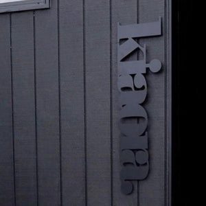 Outdoor Wall Art NZ made.  Black outdoor wall decor on black homse.