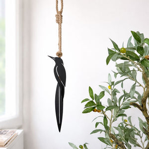 Kingfisher and flax metal wall hanging installed outdoors on exterior wall