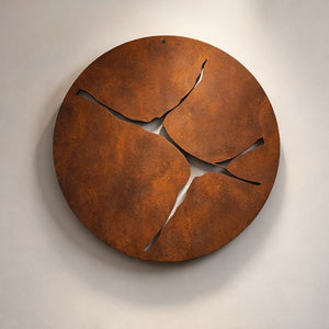 Large round corten steel "kintsugi" inspired modern wall art on living room wall in Auckland home
